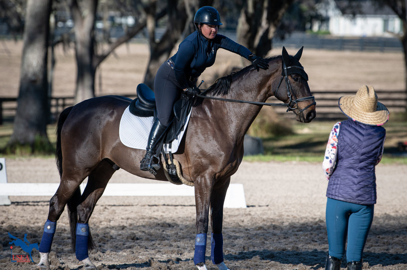 Connor Geisselman gives her horse a pat after the Modified lesson. USEA/ Meagan DeLisle photo.
