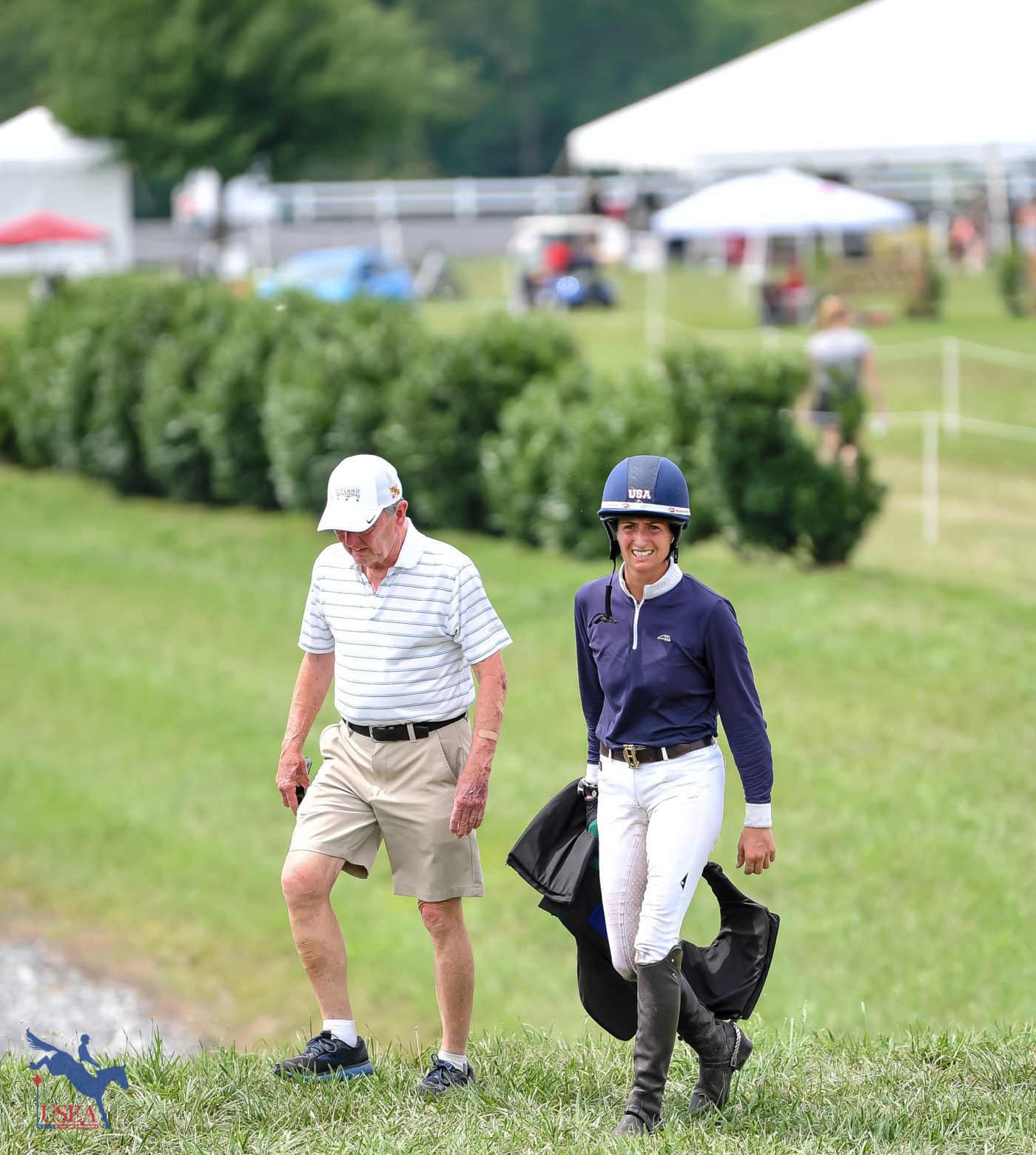 Jennie Saville walks with one of FE Connory's owners, Tim Gardner. USEA/Lindsay Berreth photo