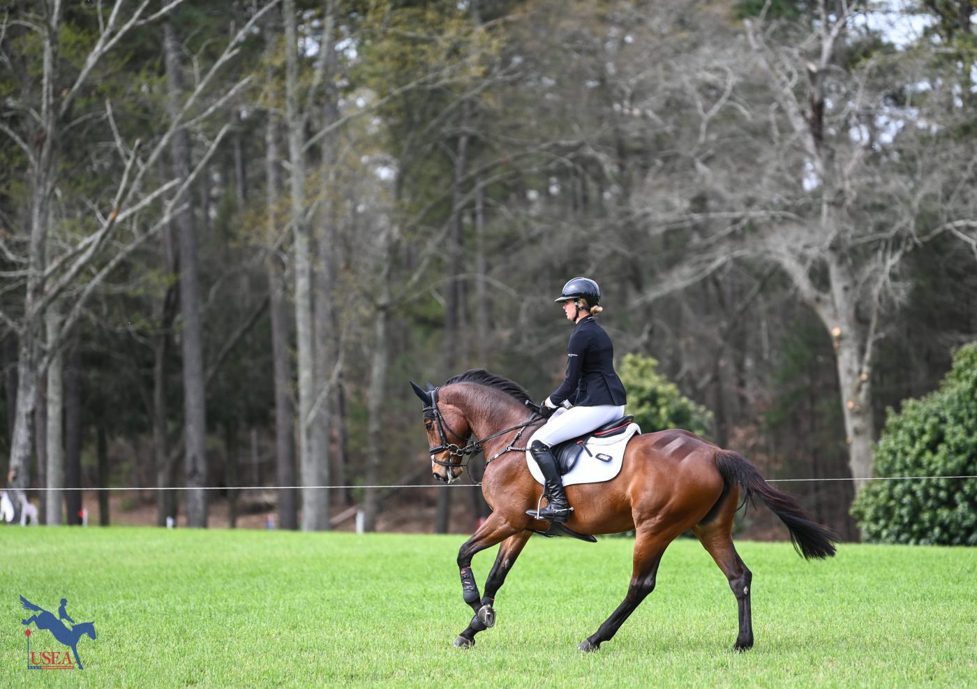 Caroline Martin warms up by the pines in the CCI3*-S. USEA/Lindsay Berreth photo