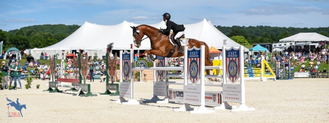 Cornelia Dorr and Louis M show jumping in the Fleming Farm Arena in front of the crowds. USEA/Jessica Duffy Photo.